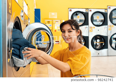 Asian people using qualified laundry machine in the public room. Asian people using qualified laundry machine in the public room. 98242741