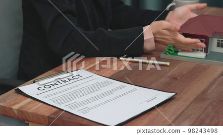 Closeup enthusiastic customer review contract paperwork for house loan. Closeup enthusiastic customer review contract paperwork for house loan. 98243498