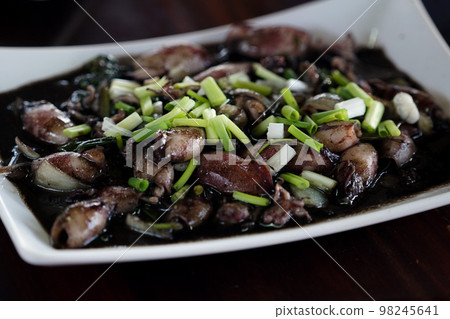 Aerial view dish of stir fried squid with ink ready for serve at the restaurant 98245641