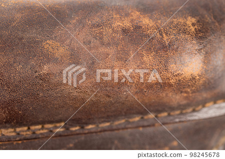 Old brown leather with a sewn seam. Old brown leather with a sewn seam. 98245678