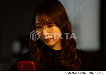 加班期間使用智能手機的女性 98245772