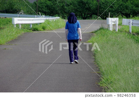 A woman taking a walk A woman's walk A woman taking a walk A woman's walk 98246358