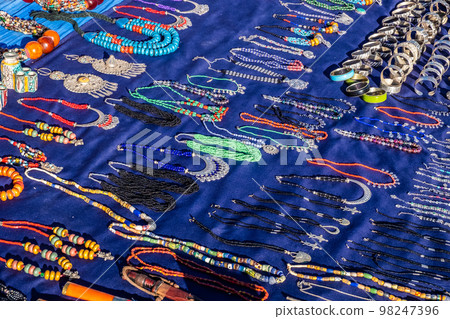 A colorful Moroccan market scene along a bustling street selling handcrafted goods 98247396