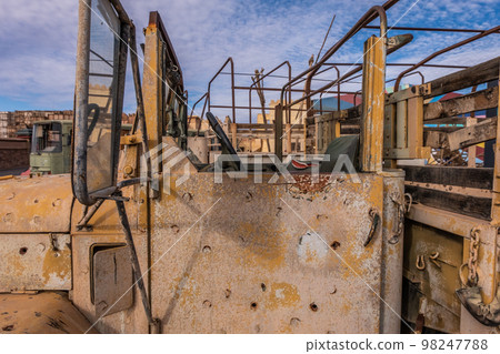 Abandoned and rusty military vehicles in the middle of the desert Abandoned and rusty military vehicles in the middle of the desert 98247788