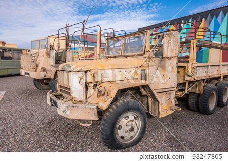 Abandoned and rusty military vehicles in the middle of the desert Abandoned and rusty military vehicles in the middle of the desert 98247805
