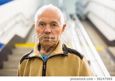 Portrait of old man going to metro station Portrait of old man going to metro station 98247869