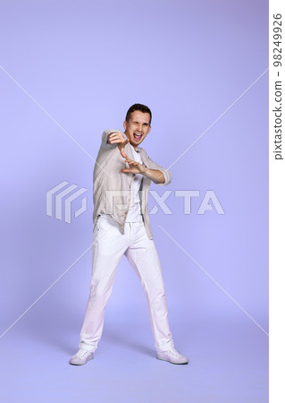 optimistic caucasian young man pointing finger on camera optimistic caucasian young man pointing finger on camera 98249926