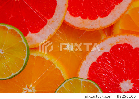 Top view: citrus fruits slices - lemon, orange, grapefruit and lime - close up 98250109