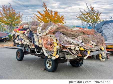 Trawler fishing net and floats stored on auto trailer Trawler fishing net and floats stored on auto trailer 98251468