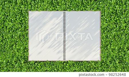 Green garden and sketchbook background with shadow of the rising sun Green garden and sketchbook background with shadow of the rising sun 98252648