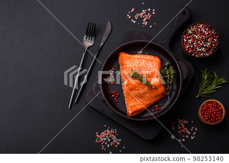 Delicious baked salmon red fish steak with spices and herbs 98253140
