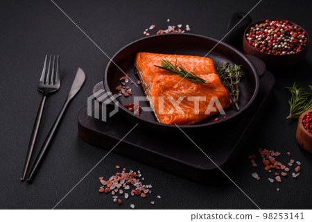 Delicious baked salmon red fish steak with spices and herbs 98253141