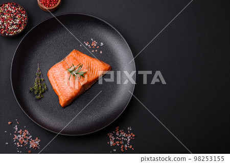 Delicious baked salmon red fish steak with spices and herbs Delicious baked salmon red fish steak with spices and herbs 98253155