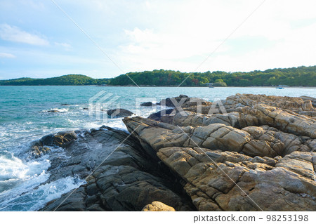 Rocky sea bach wave against blue sky Rocky sea bach wave against blue sky 98253198