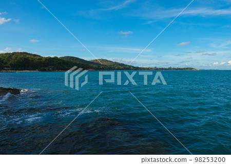 Rocky sea bach wave against blue sky Rocky sea bach wave against blue sky 98253200