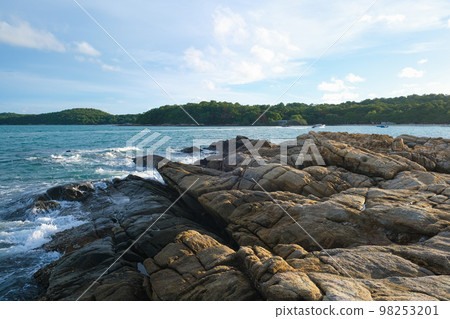 Rocky sea bach wave against blue sky Rocky sea bach wave against blue sky 98253201