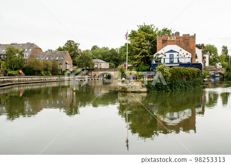 A historic brick building on the banks of the River Thames in Oxford 98253313