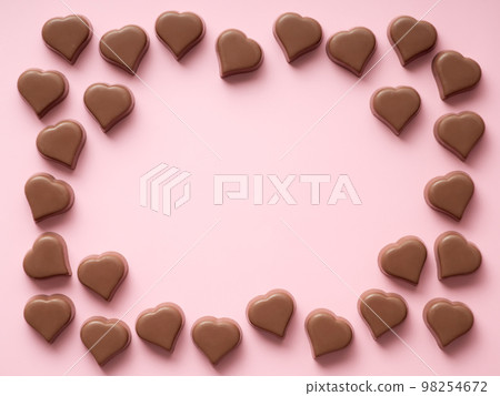 Chocolate hearts confections frame on pink, copy space Chocolate hearts confections frame on pink, copy space 98254672