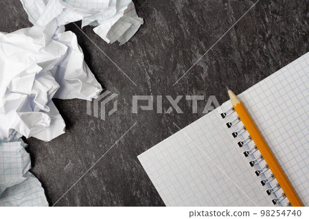 Crumpled and torn paper on the table. Notepad on crumpled paper background. 98254740