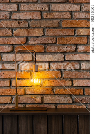 Bulb lamp against brick wall. Loft style design background. Bulb lamp against brick wall. Loft style design background. 98256103