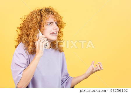 Angry woman talk to the mobile phone Angry woman talk to the mobile phone 98256192