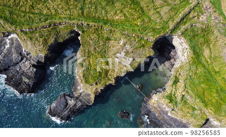Grassy cliffs on the Atlantic Ocean coast. Landscape of Ireland from a height. Seaside rocks. Drone point of view. 98256585
