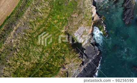 Grassy cliffs on the Atlantic coast. Landscape of Ireland from a height. Seaside rocks. Grassy cliffs on the Atlantic coast. Landscape of Ireland from a height. Seaside rocks. 98256590