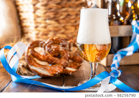 Oktoberfest beer. Foamy beer is poured into a glass and the decor of the oktober fest in germany.  98256790