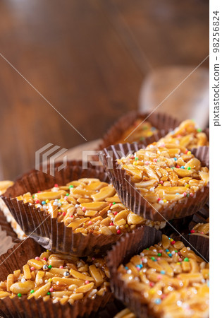 Desserts with almonds, peanuts and seeds in caramel. Traditional Sardinian sweet. Sweet squares 98256824