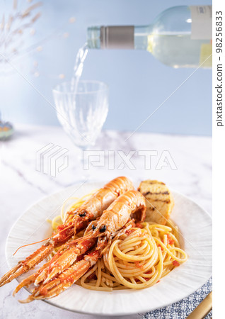 A plate with seafood for the festive table. Pasta with Norwegian lobster and white wine. Food for A plate with seafood for the festive table. Pasta with Norwegian lobster and white wine. Food for 98256833
