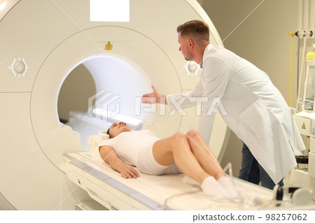 Doctor examining female patient with CT scanner in hospital. 98257062