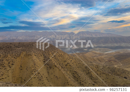 Azat reservoir with Yeranos mountain range in the background. Beautiful dramatic colorful cloudy sunset in a rocky canyon. 98257131