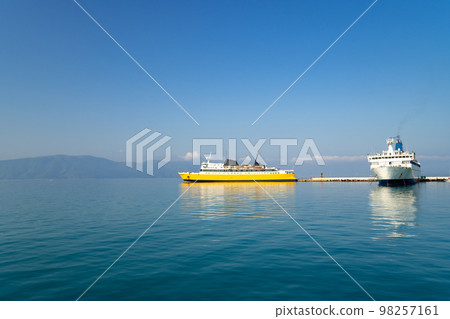 Harbour of Funchal on Madeira island Portugal with two big cruise ships on a blue sky day. Departure of one vessel and another on the pier. Popular all year destination for international tourists. 98257161