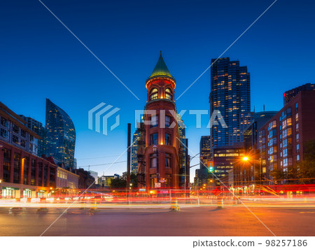 Canada, Toronto. The famous Gooderham building and the skyscrapers in background. Canada, Toronto Canada, Toronto. The famous Gooderham building and the skyscrapers in background. Canada, Toronto 98257186