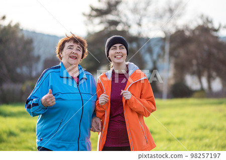 Portrait of happy grandmother and adult granddaughter have fun talking. Family time. Park on the background. International Day of Older Persons 98257197