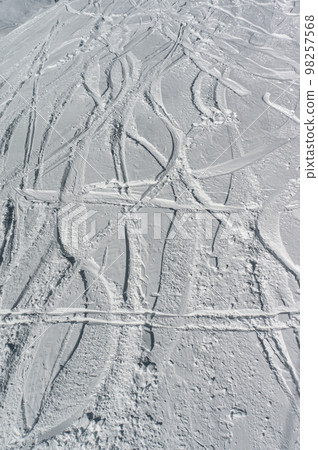 deep trace from ski and snowboard on snow winter mountain slope, freeride 98257568