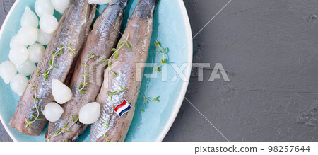 Freshly salted herring with salt, with copy space. Traditional Dutch delicacy. Freshly salted herring with salt, with copy space. Traditional Dutch delicacy. 98257644