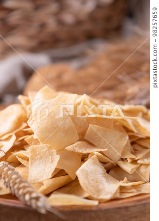 Bread chips, a typical appetizer for aperitivo, dinner in southern Italy and Sardinia. Thin baked Bread chips, a typical appetizer for aperitivo, dinner in southern Italy and Sardinia. Thin baked 98257659