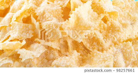 Sfrappole or chiachiere or angel wings background. 98257661