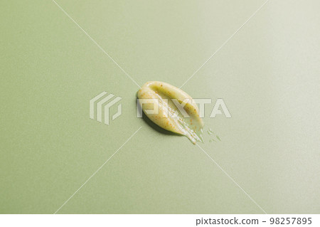 Beauty product, face body scrub cream mask, smear sample. Natural cosmetics texture green background Beauty product, face body scrub cream mask, smear sample. Natural cosmetics texture green background 98257895