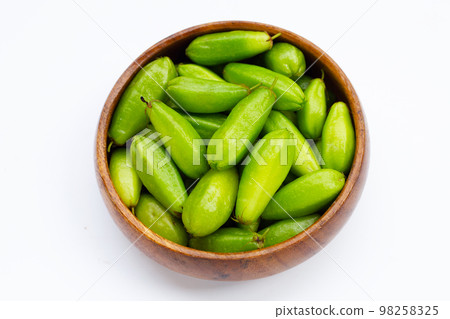 Bilimbi fruit in bamboo basket on white background. 98258325