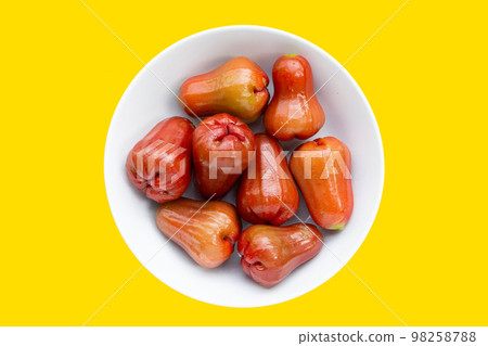 Fresh rose apple on yellow background. Fresh rose apple on yellow background. 98258788