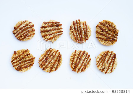 Rice cracker with coconut palm sugar on white Rice cracker with coconut palm sugar on white 98258814