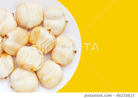 Toddy palm in white plate on yellow background. 98258815