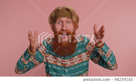 Amazed hippie man surprise looking at camera with big eyes, shocked by sudden victory, wow emotion 98259183