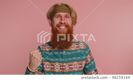 Hippie man in pattern shirt shouting raising fists in gesture I did it, celebrating success winning 98259184