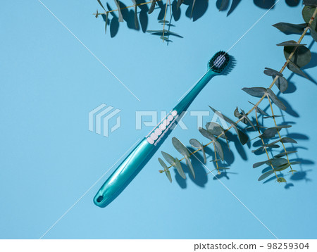 Plastic toothbrush on a blue background 98259304