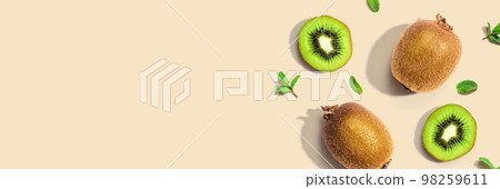 Fresh green kiwis overhead view 98259611