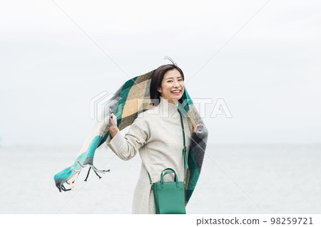 woman going out to the sea in winter woman going out to the sea in winter 98259721