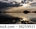 Scenery of a sandy beach with a beautiful reflection of the sunset sky 98259915